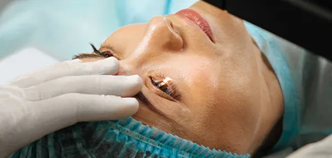 Woman undergoing cataract surgery with laser treatment on eye in Turkey