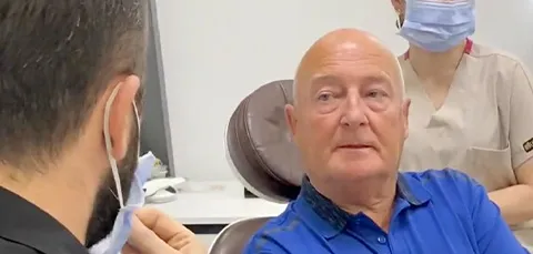 Older male patient in consultation with dentist before dental implant procedure