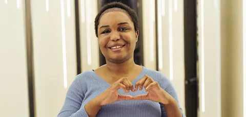 Smiling woman showing hair regrowth and confidence after female pattern hair loss treatment