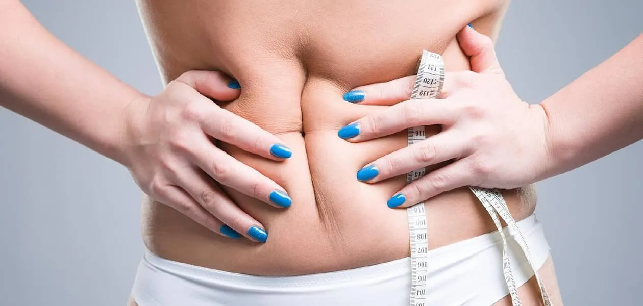 woman squeezing her belly