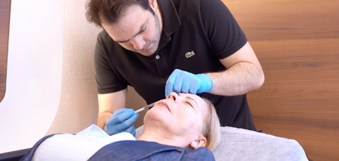 Woman in Turkey receiving liquid facelift with dermal fillers and Botox, doctor performing non-surgical facial rejuvenation.