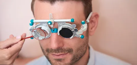 Man receiving a vision test to determine the correct power for multifocal intraocular lenses (IOLs)