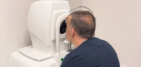 Male patient undergoing eye scan during ophthalmology diagnostic check