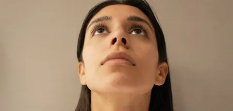 Woman before rhinoplasty in Turkey showing nasal shape from below, preparing for nose reshaping surgery.