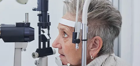 Senior woman undergoing a comprehensive eye examination to assess cataract progression