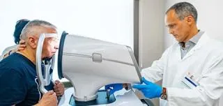 Senior man during a glaucoma inspection with a scanner