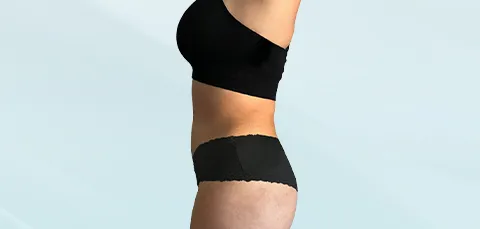 A side profile of a torso, illustrating the areas targeted by an extended vs. regular tummy tuck procedure