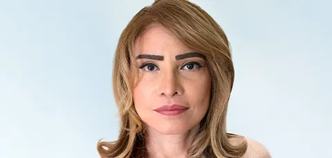Headshot of a woman with youthful, rejuvenated skin, looking directly at the camera.