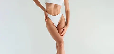 Woman in white underwear with sleek, toned thighs illustrating sculpted results after spiral thigh-lift (spiral thighplasty