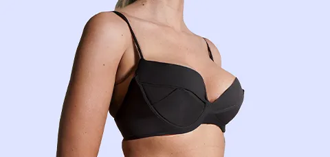 Side view of a woman after tuberous breast correction surgery in Turkey showing symmetrical breast shape